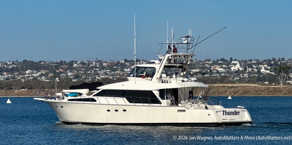 A white sport fishing yacht named “Thunder” cruising on the water.