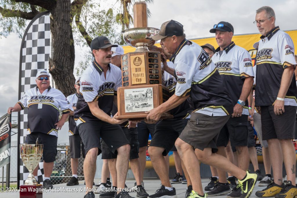 Members of the BWR Racing team hold up the Bill Muncey Cup trophy during a presentation ceremony.