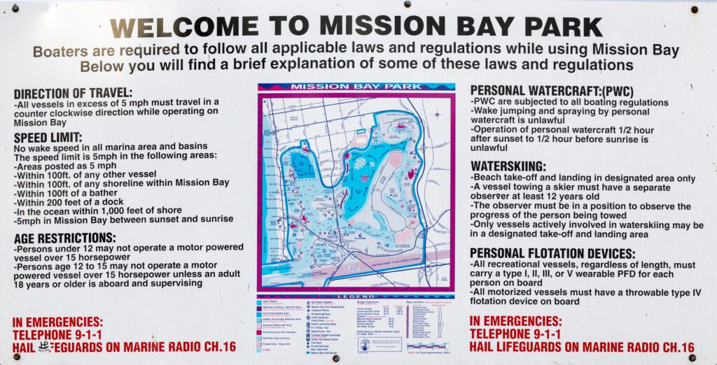 Informational sign for Mission Bay Park listing boating regulations, speed limits, age requirements, and watercraft rules, including a map of the area with a legend.