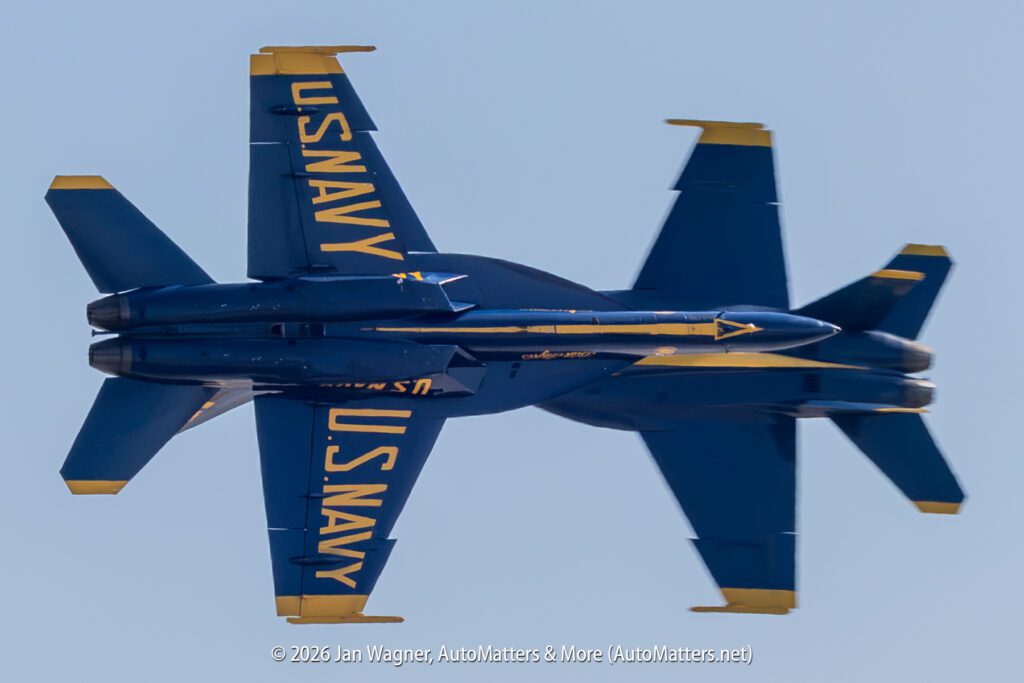 Two U.S. Navy Blue Angels F/A-18 Hornet aircraft flying in close formation against a clear sky.