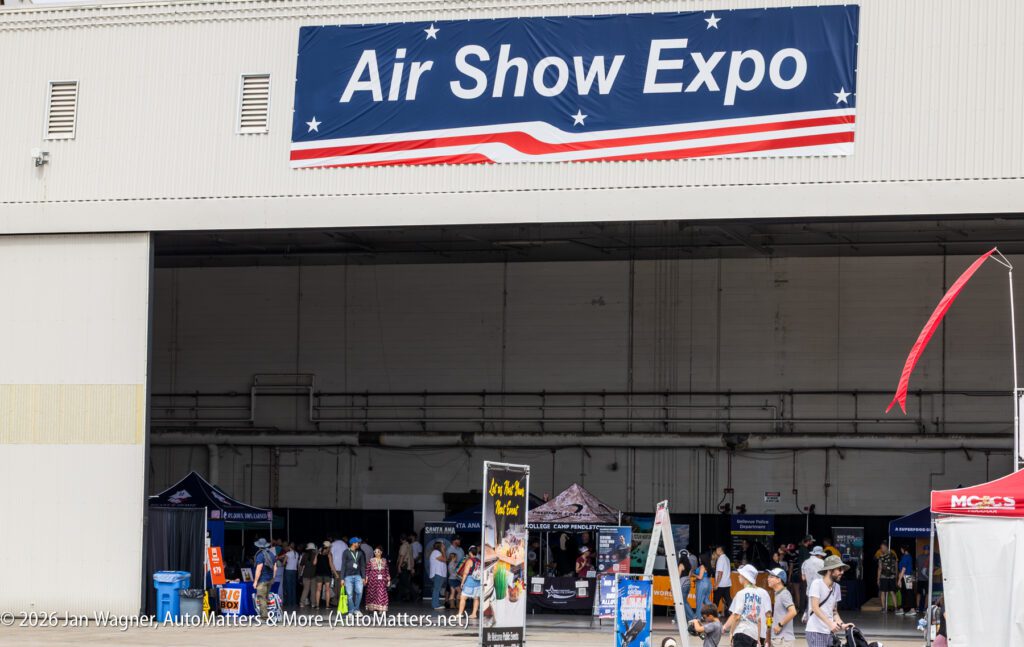 People walk into a large hangar during an Air Show Expo.