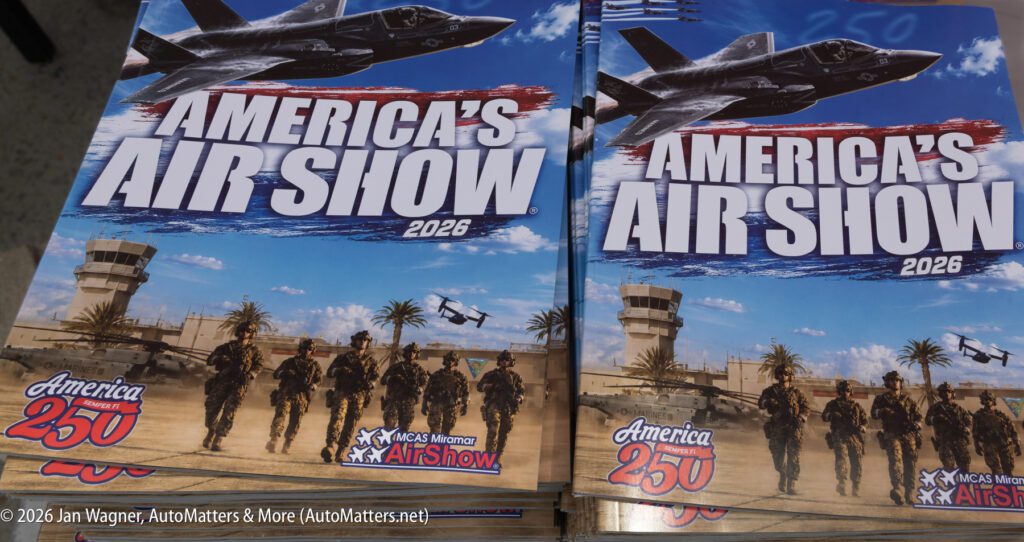 Stacks of promotional flyers for America’s Air Show 2026, featuring a fighter jet and a group of soldiers in formation.