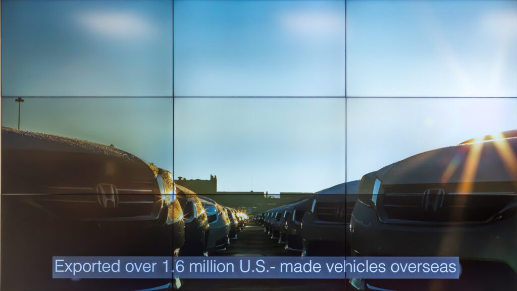 Rows of parked Honda cars with text overlay: “Exported over 1.6 million U.S.-made vehicles overseas.”