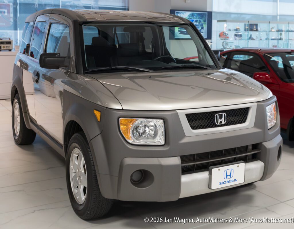 Silver Honda Element parked inside a showroom.